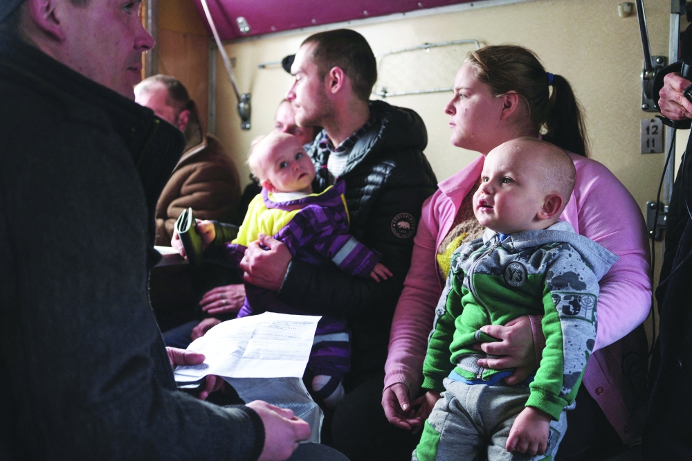 Iryna Hryhorieva sits with her son Bohdan, inside an evacuation train, after leaving their village of Min'kivka, located near the Bakhmut frontline, at the train station in Pokrovsk, Donetsk region. - Reuters
