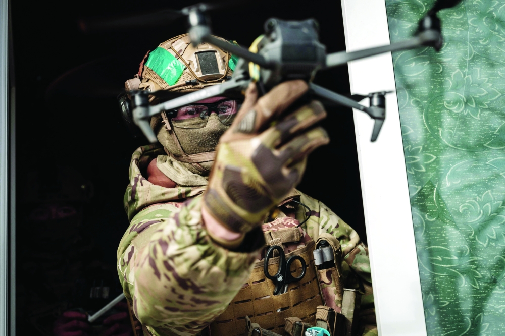 A Ukrainian serviceman of the State Border Guard Service demonstrates a drone with a mimic grenade in Bakhmut amid the Russian invasion of Ukraine. - AFP


