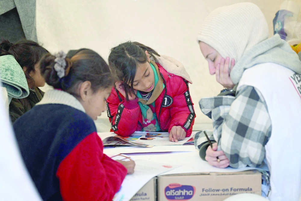 A psychologist takes care of children who have been affected by earthquake which struck the border region of Türkiye  and Syria in Kahramanmaras. -- AFP
