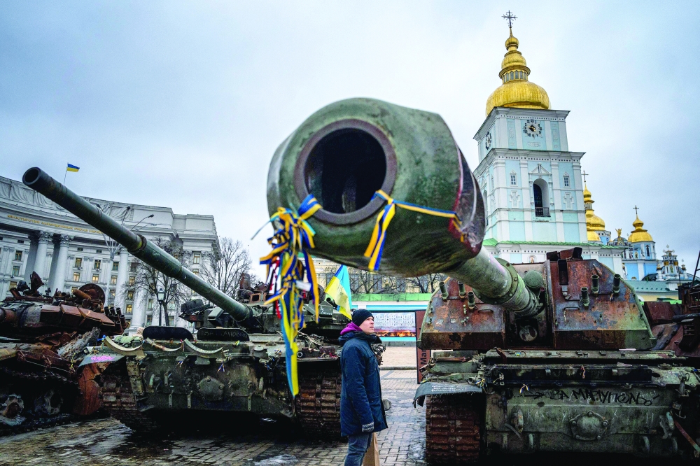 A man looks at destroyed Russian military equipment in Mykhailivska Square in downtown Kyiv amid the Russian war on Ukraine. -- AFP