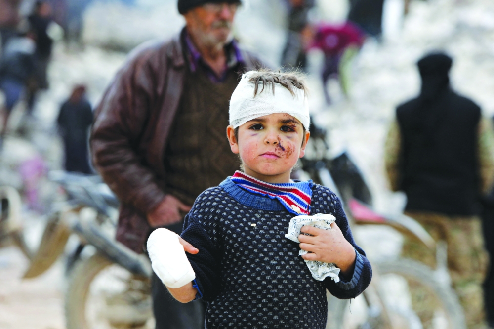 Six-year-old Musa Hmeidi, a Syrian child who was pulled out alive from under the rubble of a collapsed building, four days after a deadly earthquake hit the area, in the rebel-held town of Jindayris, Aleppo province. - AFP