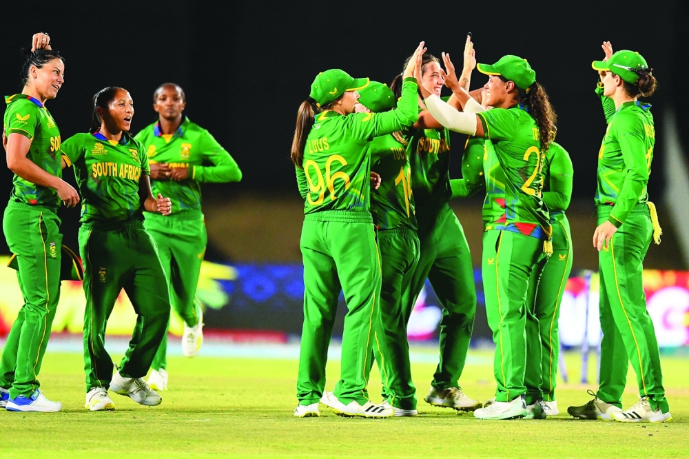 South Africa players celebrate after winning the Group A T20 women's World Cup cricket match between South Africa and New Zealand at Boland Park in Paarl on February 13, 2023. (Photo by Rodger Bosch  / AFP)

