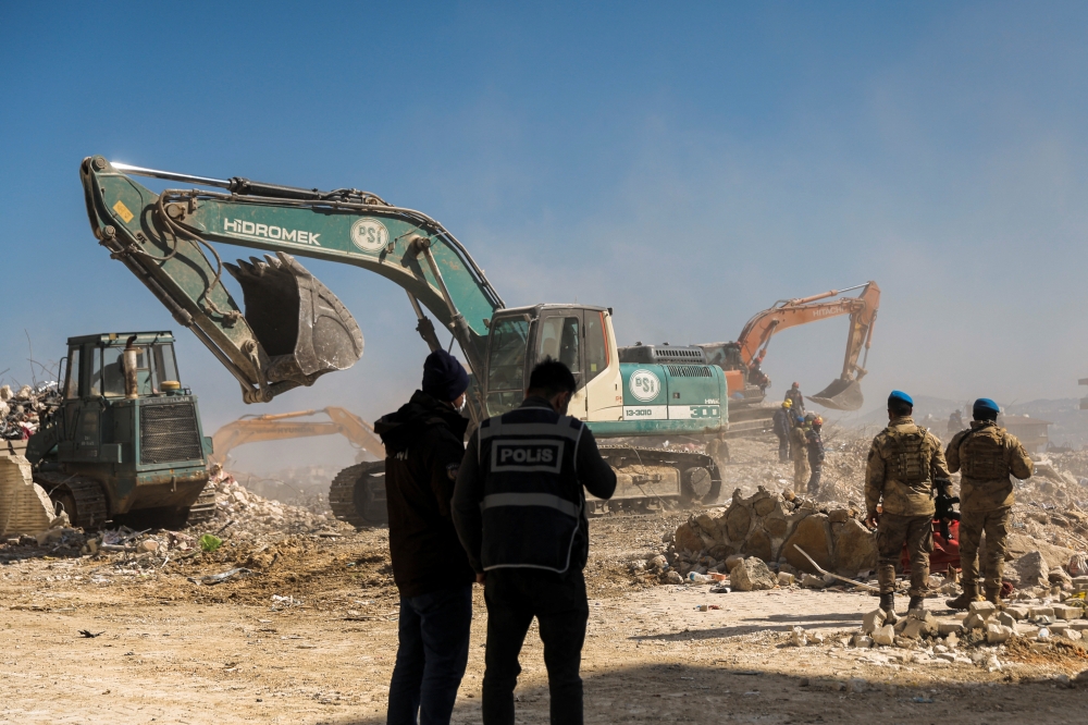 Rescuers work at the site of destroyed high-end building as rescue operations continue, in the aftermath of a deadly earthquake in Antakya, Turkey February 16, 2023.