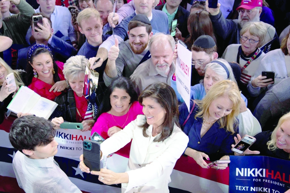 Former US ambassador to the UN Nikki Haley poses for a selfie with a crowd of supporters. -- AFP