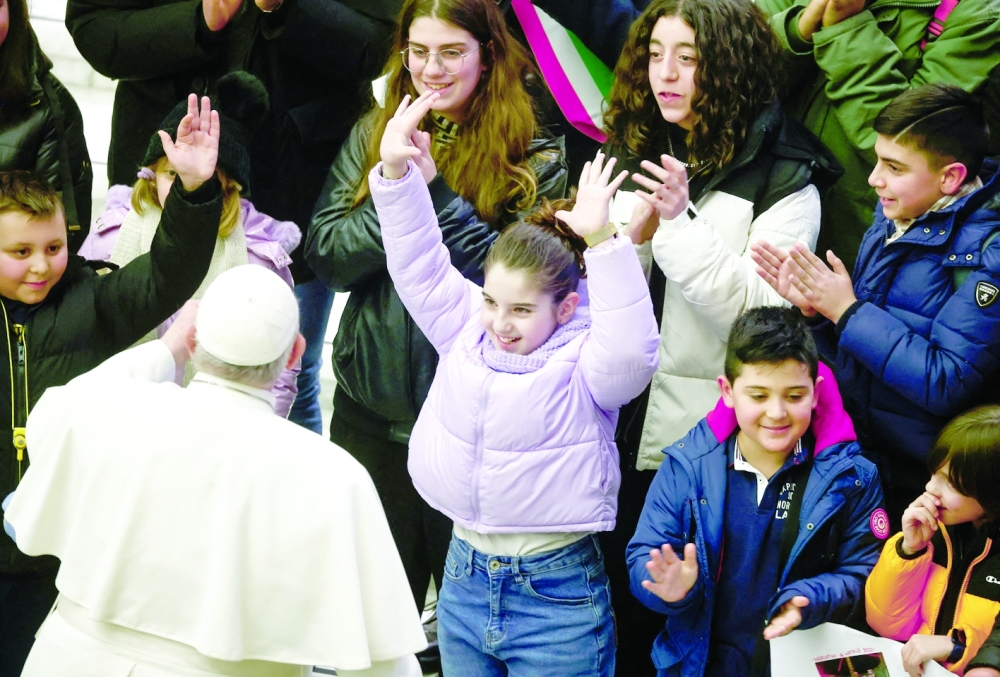 Pope Francis interacts with children as he attends the weekly general audience at the Vatican. -- Reuters

