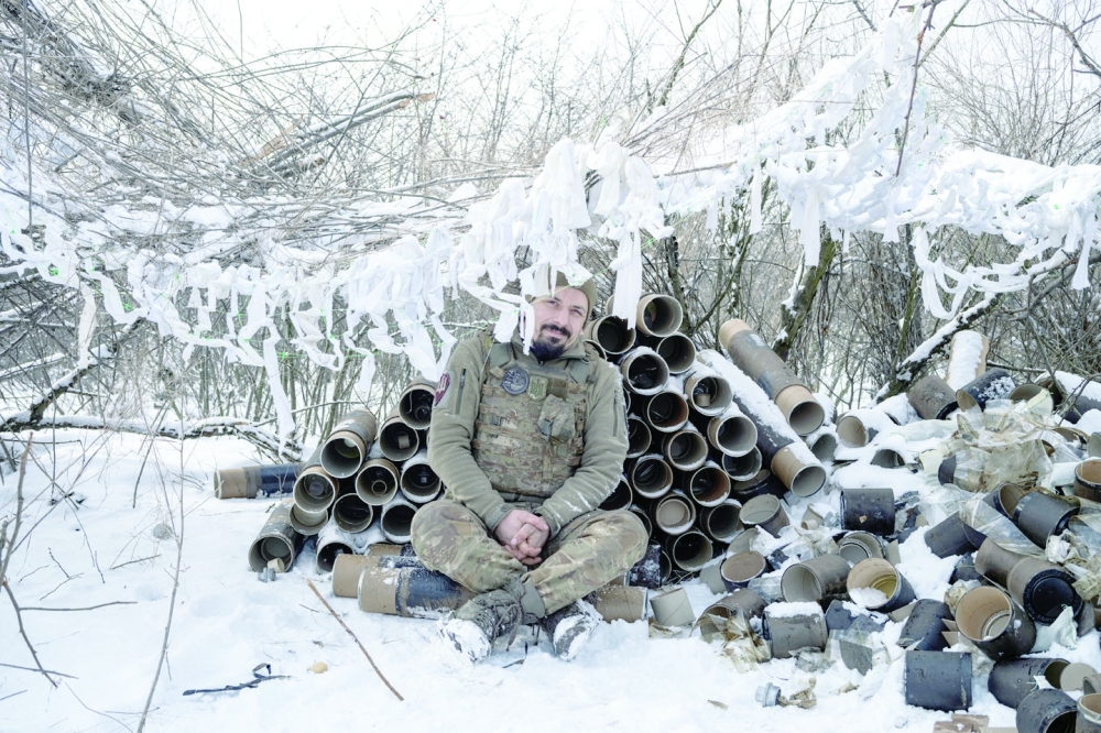 A Ukrainian serviceman of the 80th Air Assault Brigade takes a break after firing an M119 Howitzer artillery weapon towards Russian troops near Bahmut. -- Reuters