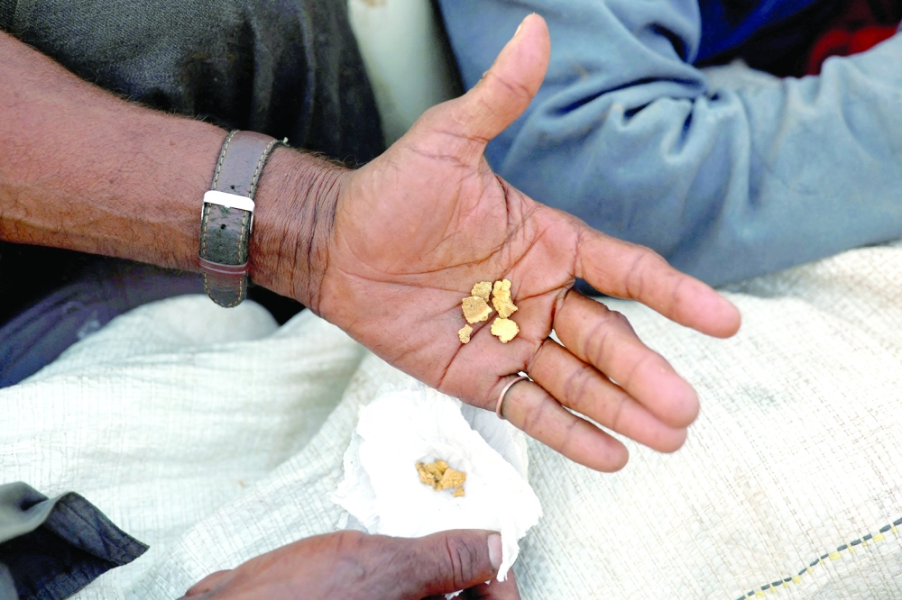 A miner shows gold after, according to him, leaving illegal mining at Yanomami indigenous land, in Alto Alegre. Around half of the 100 tonnes of gold produced each year by Brazil is thought to be illegally mined and laundered by financial brokerages. -- Reuters