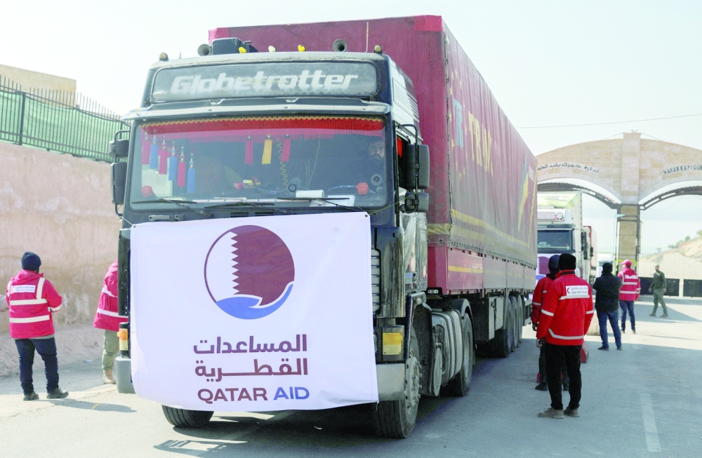 Convoy of trucks carrying humanitarian aid from Qatar to quake-hit northwest Syria drive at the border crossing of Bab al-Hamam in rebel-held town of Afrin on Thursday. — Reuters