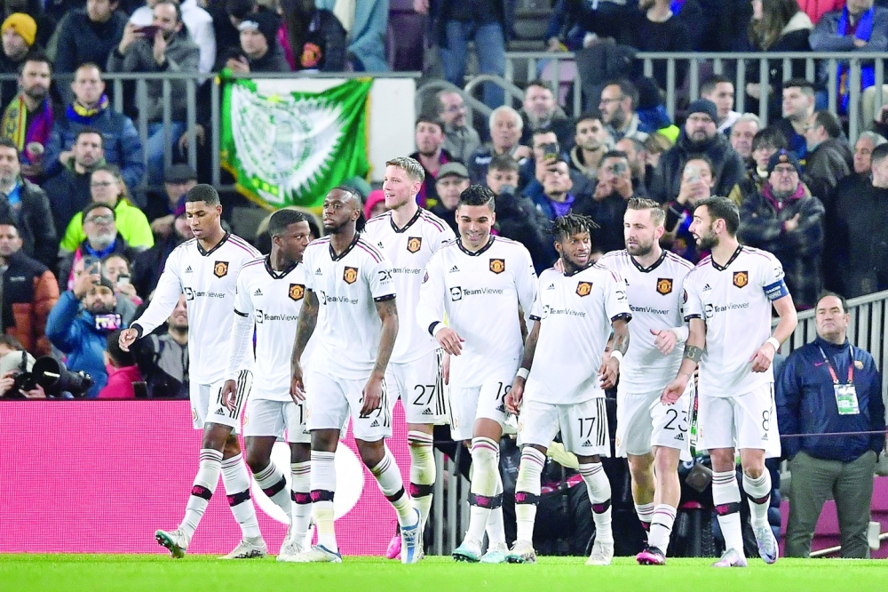 Manchester United's players celebrate after scoring a goal during the UEFA Europa League round of 32 first-leg football match between FC Barcelona and Manchester United at the Camp Nou stadium in Barcelona, on February 16, 2023. (Photo by Pau BARRENA / AFP)

