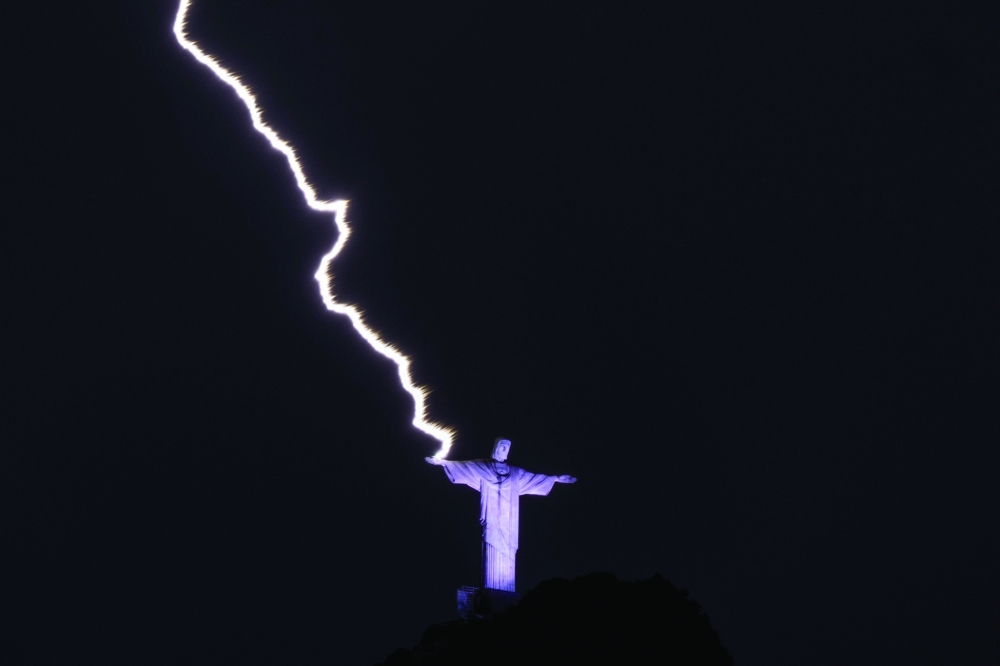 A lightning hits the hand of the Christ the Redeemer statue at the Corcovado mountain in Rio de Janeiro, Brazil, on Tuesday night. - AFP