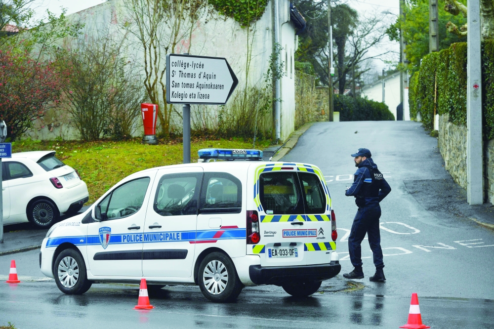 Police secure a perimeter around the school where a teacher died after being stabbed by a student, in Saint-Jean-de-Luz, on Wednesday. — AFP