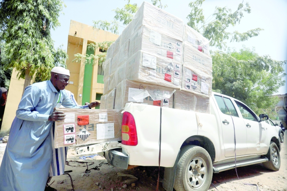 A man loads boxes of ballot papers into a dispatch vehicle at the Nigeria's Independent Electoral Commission office in Kano. -- AFP