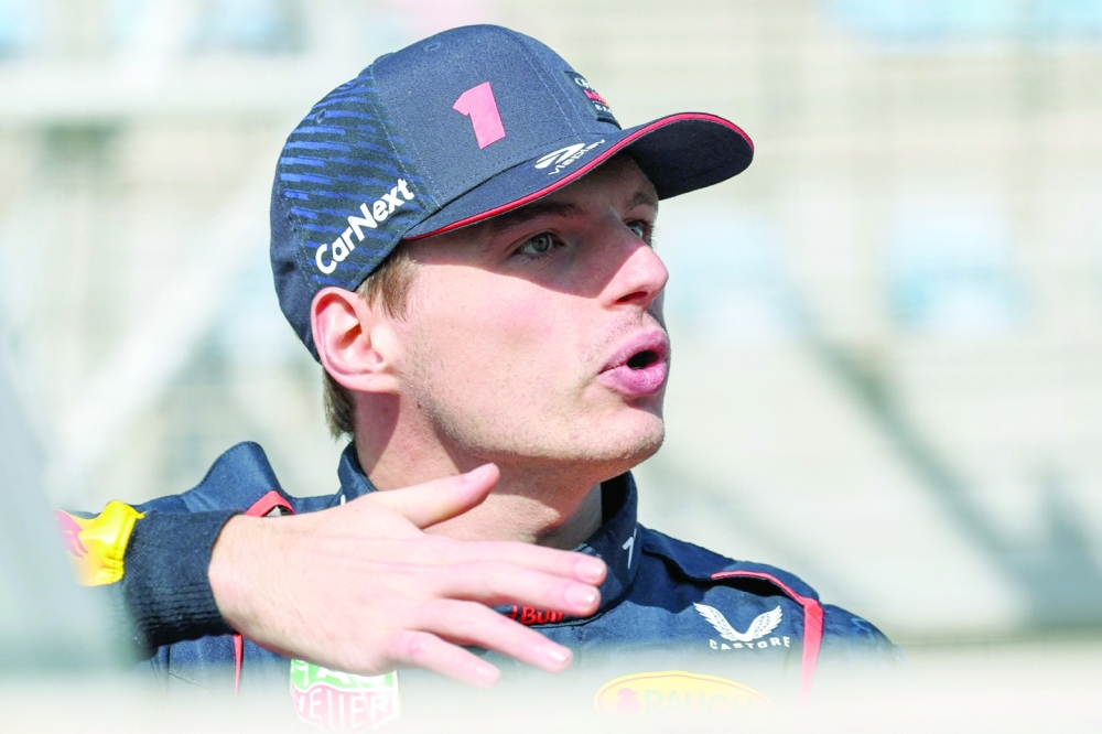 Red Bull Racing's Dutch driver Max Verstappen speaks with another driver as they arrive for the first day of Formula One pre-season testing at the Bahrain International Circuit in Sakhir on February 23, 2023.  (Photo by Giuseppe CACACE  / AFP)

