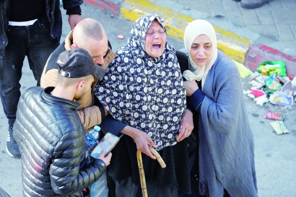 A woman reacts during a funeral of 10 Palestinians in Nablus. — Reuters