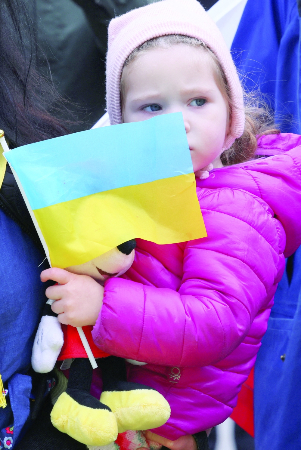 A child holds an Ukrainian flag in front of the EU Parliament building in Brussels. On the first anniversary of the war, leaders across Europe joined in ceremonies underlining unwavering support for Ukraine and commemorating victims of the conflict. -- Reuters
