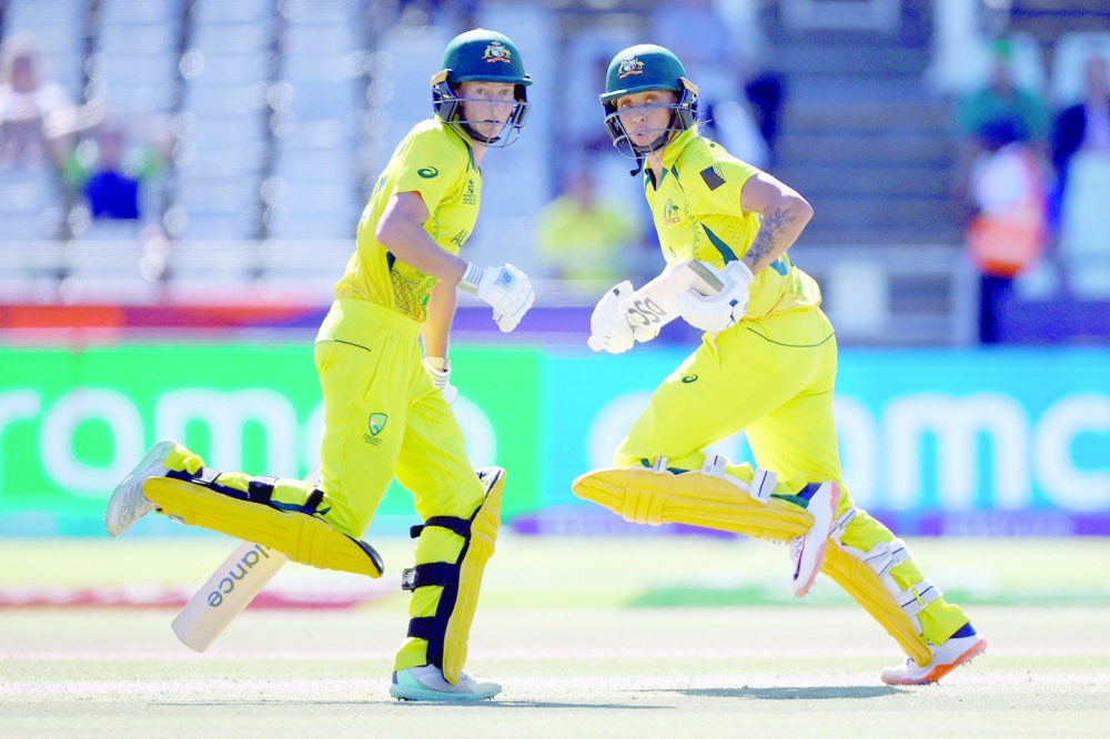 TOPSHOT - Australia's Ashleigh Gardner (R) and Australia's Meg Lanning (L) run between the wickets during the semi-final T20 women's World Cup cricket match between Australia and India at Newlands Stadium in Cape Town on February 23, 2023. (Photo by Marco Longari / AFP)

