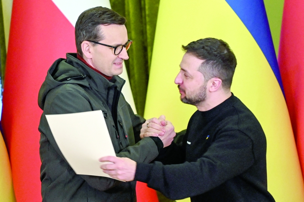 Ukraine's President Zelenskiy receives documents for Leopard tanks from Polish Prime Minister Mateusz Morawiecki during a joint news briefing in Kyiv. - Reuters

