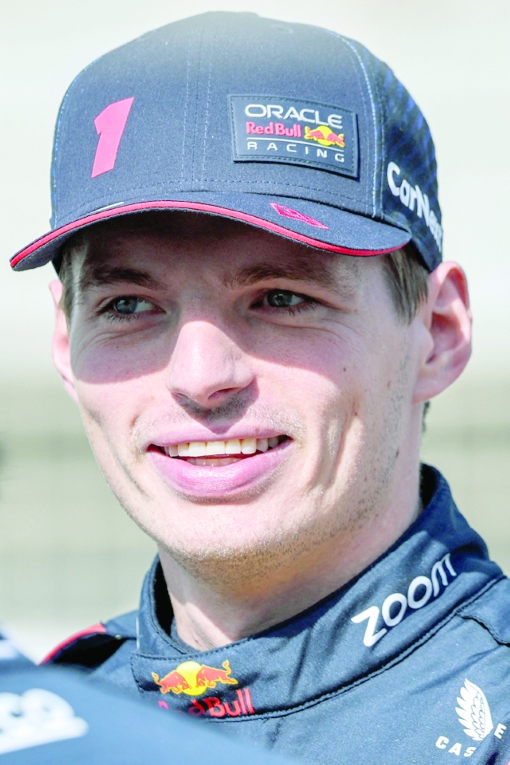 Red Bull Racing's Dutch driver Max Verstappen speaks with his teammate as they arrive for the first day of Formula One pre-season testing at the Bahrain International Circuit in Sakhir on February 23, 2023.  (Photo by Giuseppe CACACE  / AFP)

