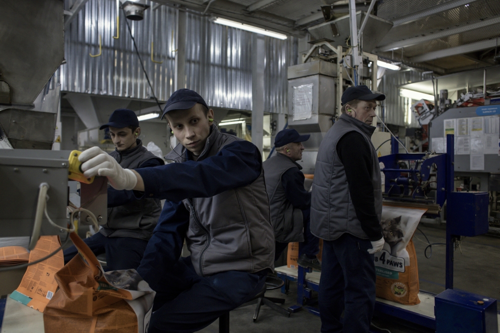 Workers at the Kormotech factory in Prylbychi, Ukraine, Feb. 10, 2023. (Maciek Nabrdalik/The New York Times)