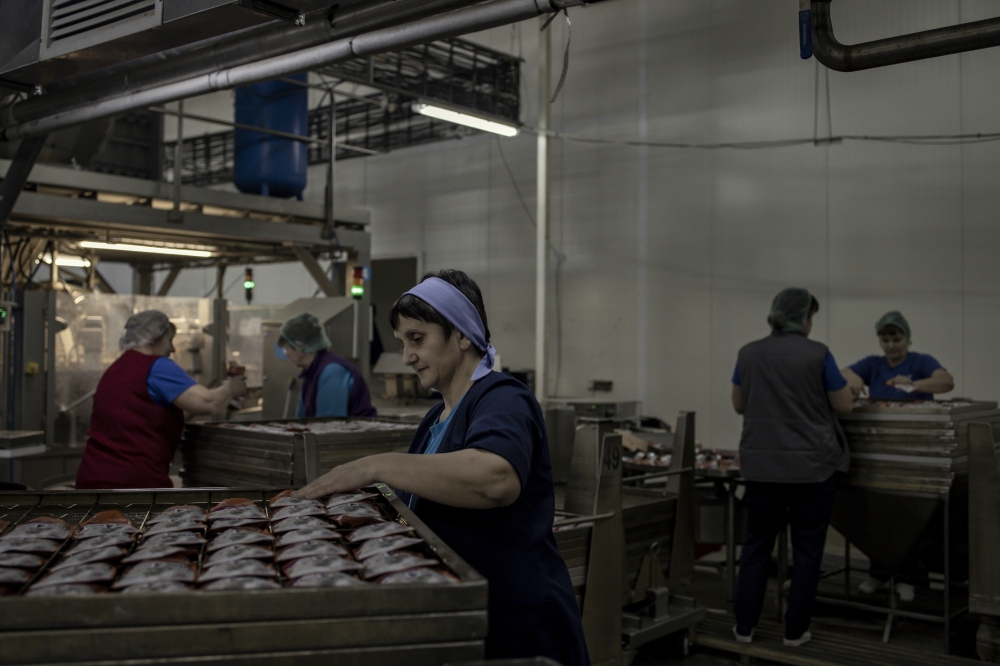 Workers at the Kormotech factory in Prylbychi, Ukraine, Feb. 10, 2023. (Maciek Nabrdalik/The New York Times)