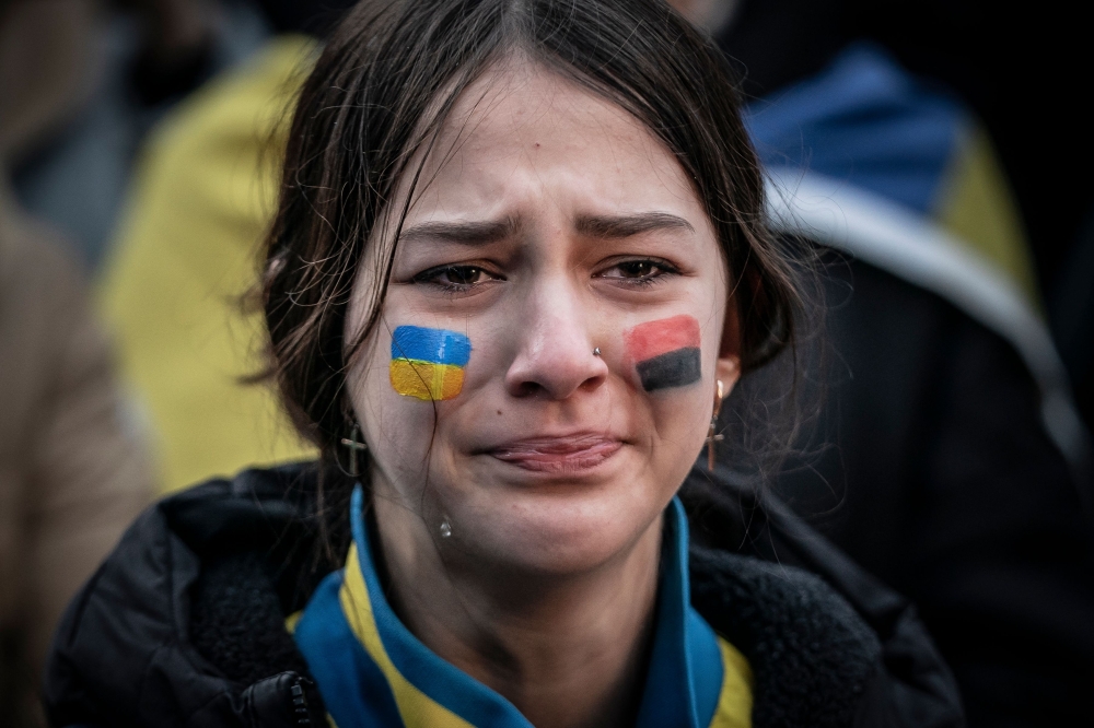 A young woman reacts during a rally marking the first anniversary of the Russian war on Ukraine in front of the Russian Embassy in Copenhagen, on Friday. - AFP

