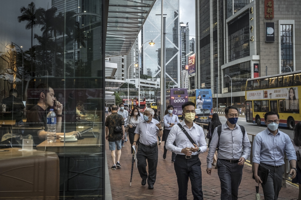 People walk in the center of Hong Kong, on June 15, 2022. (Sergey Ponomarev/The New York Times)