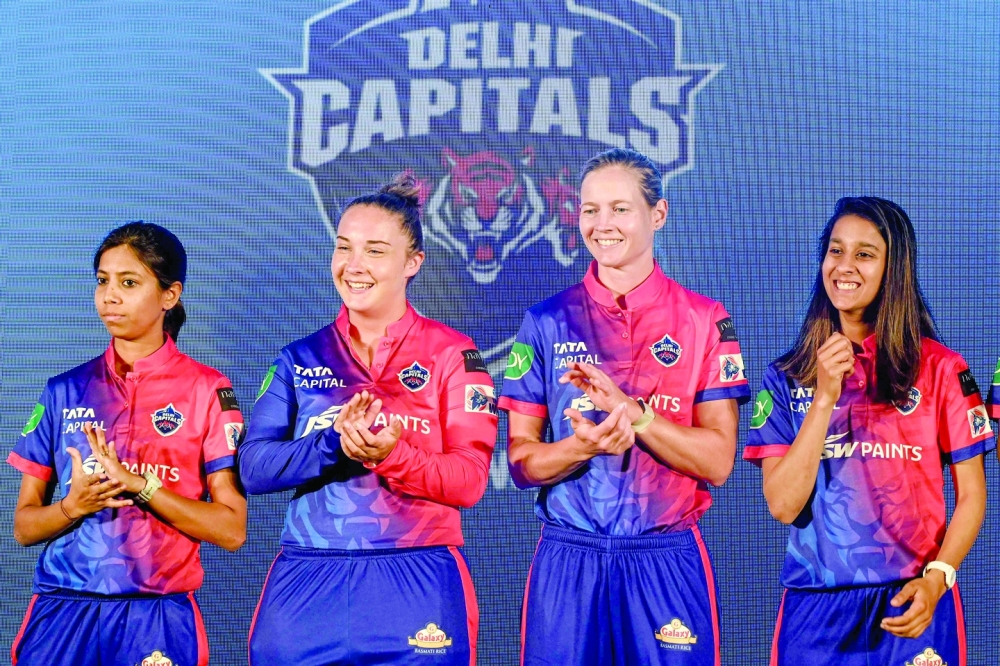 (L-R) Delhi Capitals cricketers Aparna Mondal, Alice Capsey, Meg Lanning and Jemimah Rodrigues applaud their teammates during a press conference ahead of the inaugural Women's Premier League (WPL), in Mumbai on March 2, 2023.  (Photo by Indranil MUKHERJEE / AFP)

