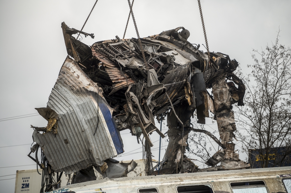 A crane is used to clear wreckage at the site of a train crash near the city of Larissa, Greece on Wednesday, March 1, 2023. (Angelos Tzortzinis/The New York Times)