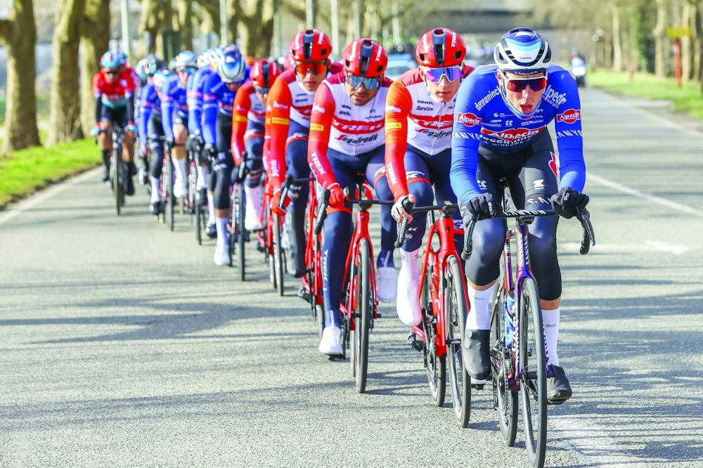 The pack rides during the Grand Prix du Samyn, 209km one-day cycling race between Quaregnon and Dour in Belgium, as part of the Lotto Cycling Cup, in Quaregnon, on February 28, 2023.  - Belgium OUT
 (Photo by DAVID PINTENS / BELGA / AFP)

