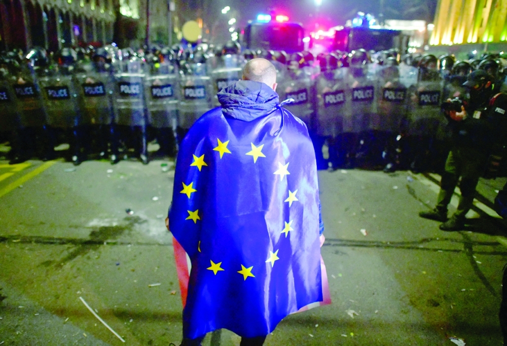 A demonstrator wears a European Union flag during a protest against a draft law on "foreign agents" in Tbilisi. — Reuters 