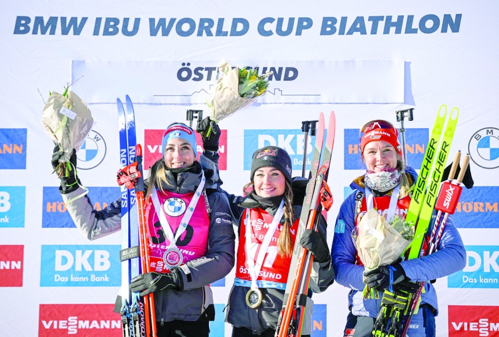 (L to R) Second placed Italy's Lisa Vittozzi, Winner Italy's Dorothea Wierer and third placed Germany's Denise Herrmann-Wick (R) of Germany pose on the podium after the women's 15km individual event of the IBU World Cup Biathlon in Ostersund, Sweden, on March 09, 2023.
 Sweden OUT
 (Photo by Anders WIKLUND / TT NEWS AGENCY / AFP)

