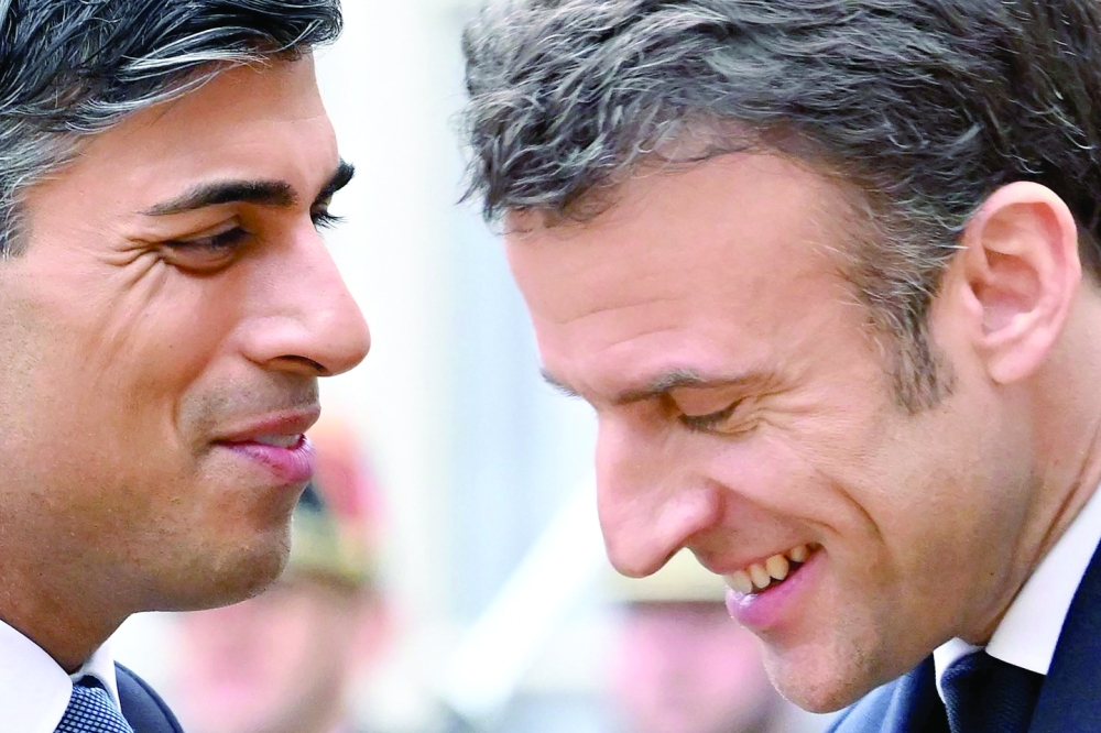 France's President Emmanuel Macron greets Britain's Prime Minister Rishi Sunak as he arrives for a meeeting on the occasion of the 36th Franco-British bilateral summit at the Elysee Palace. - AFP

