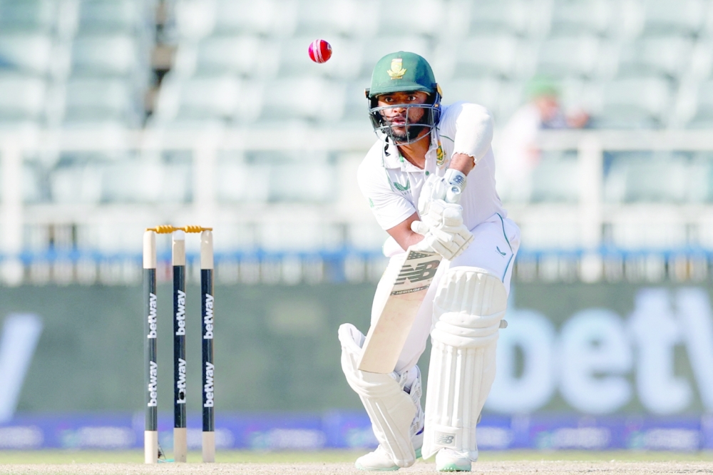 South Africa's Temba Bavuma watches the ball after playing a shot during the third day of the second Test cricket match between South Africa and West Indies at The Wanderers Stadium in Johannesburg on March 10, 2023. (Photo by PHILL MAGAKOE / AFP)

