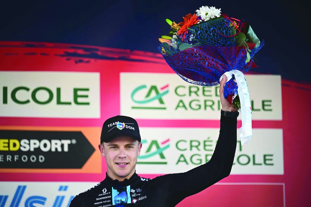 Third-placed Team DSM Dutch rider Casper van Uden celebrates on the podium  after the Milan傍urin semi classic single day cycling race, between the northern Italian cities of Milan and Turin, on March 15, 2023.  (Photo by Marco BERTORELLO / AFP)

