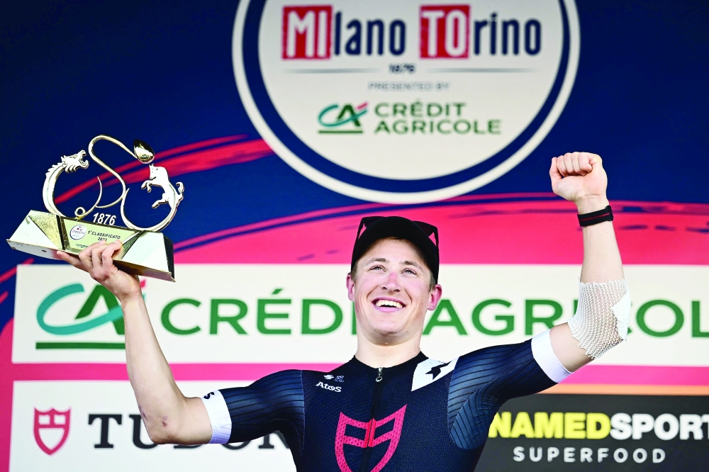 Team Tudor Dutch rider Arvid De Kleijn celebrates on the podium after winning the Milan傍urin semi classic single day cycling race, between the northern Italian cities of Milan and Turin, on March 15, 2023.  (Photo by Marco BERTORELLO / AFP)

