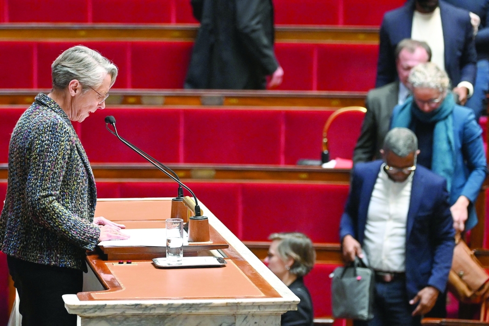 Members of Parliament of left-wing coalition leave during the speech of France's PM Elisabeth Borne (C), as she confirms to force through pension law without parliament vote, Paris. — AFP