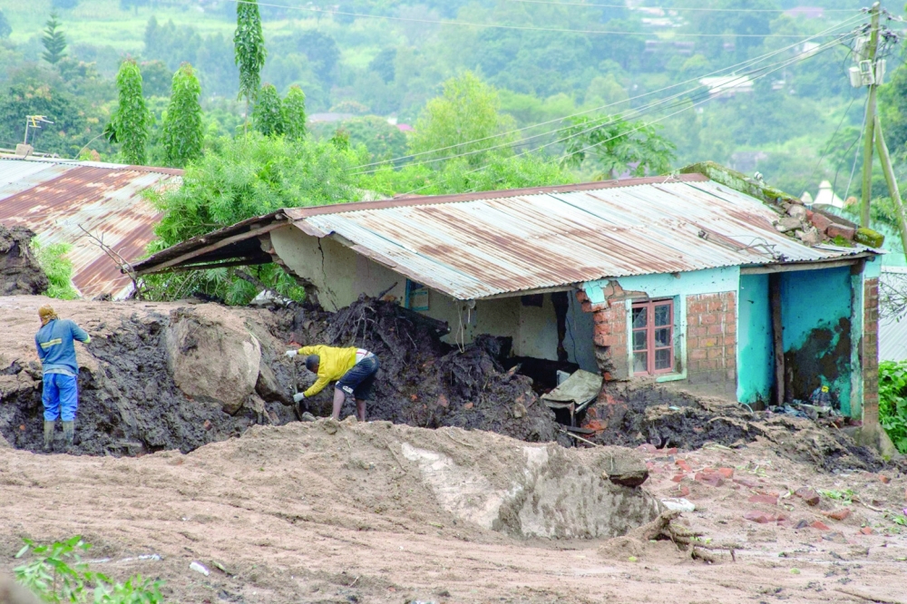 Men work to rescue their relatives, or recover their bodies, who are victims of a landslide which occurred due to heavy rains resulting from cyclone Freddy in Blantyre. — AFP 
