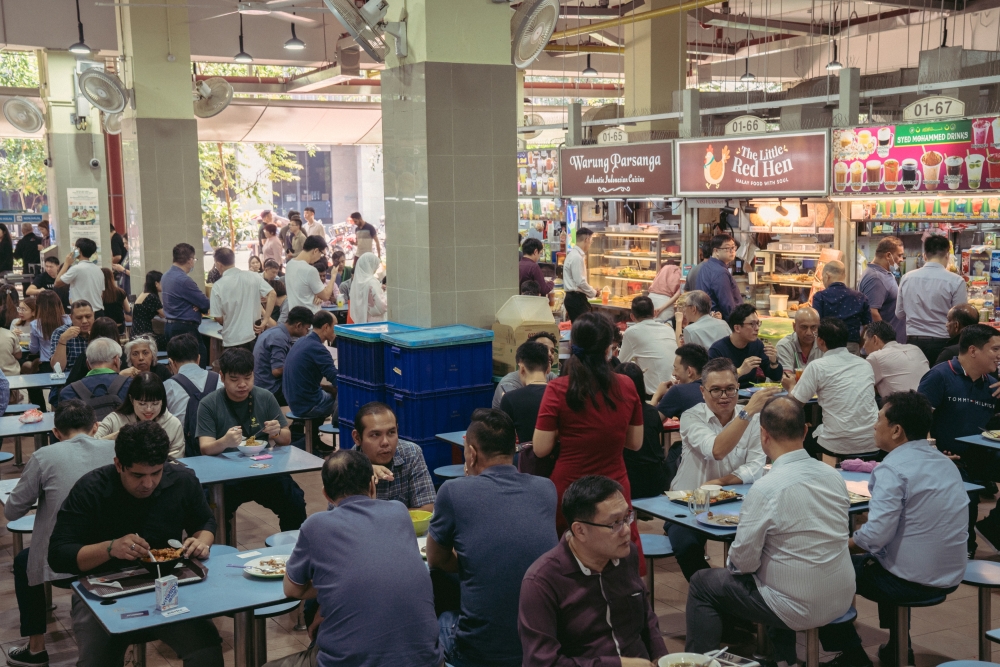 Office workers at lunchtime at Amoy Street Food Center in Singapore, March 2, 2023. (Amrita Chandradas/The New York Times)