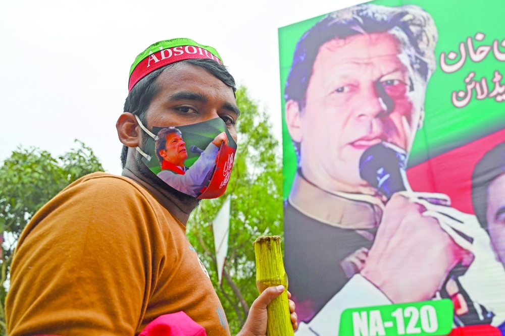 A supporter of Pakistan's former Prime Minister Imran Khan guards Khan's residence in Lahore. - AFP 