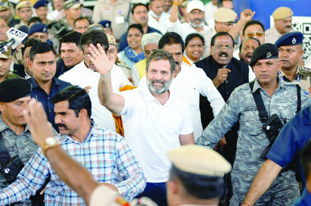 Rahul Gandhi waves towards his party supporters as he arrives at the New Delhi airport, after he appeared before a court in Surat in the western state of Gujarat, India. — Reuters