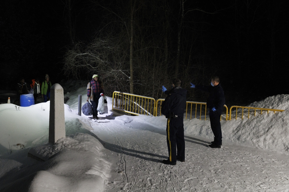 Migrants arriving at the Roxham Road border crossing in Saint-Bernard-De-Lacolle, Quebec, Canada from New York State, on Feb. 24, 2023. (Nasuna Stuart-Ulin/The New York Times)