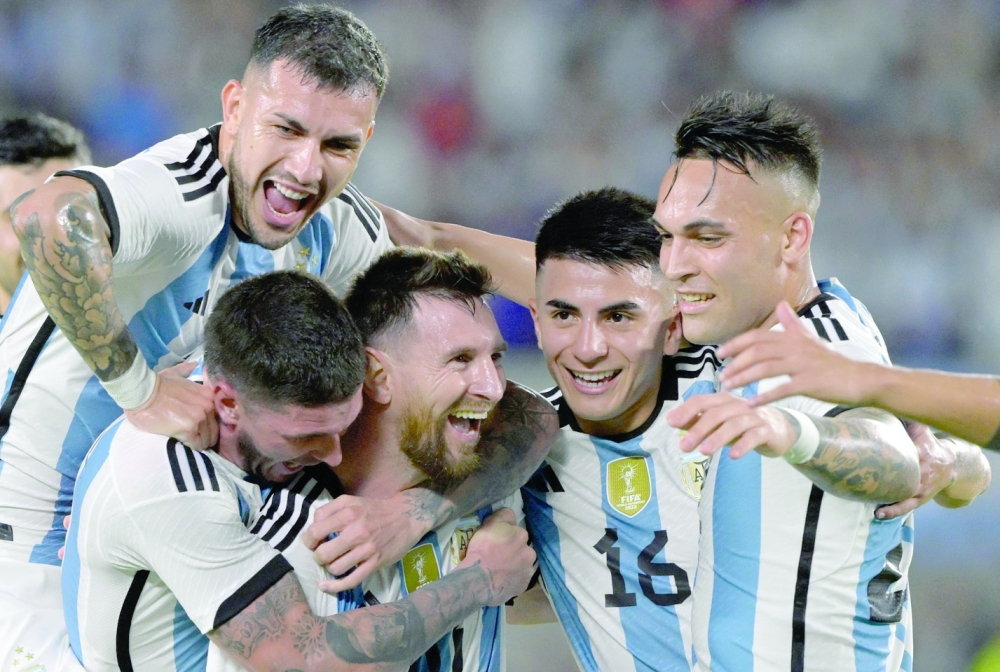 TOPSHOT - Argentina's forward Lionel Messi (C) celebrates with Argentina's  Leandro Paredes (L, top), Argentina's midfielder Rodrigo De Paul (L), Argentina's midfielder Thiago Almada (2-R) and Argentina's forward Lautaro Martinez after scoring a goal during the friendly football match between Argentina and Panama at the Monumental stadium in Buenos Aires, on March 23, 2023. Lionel Messi capped a night of unbridled joy with the 800th goal of his career as world champions Argentina celebrated their homecoming with a 2-0 friendly victory over stubborn Panama in Buenos Aires on Thursday. (Photo by JUAN MABROMATA / AFP)