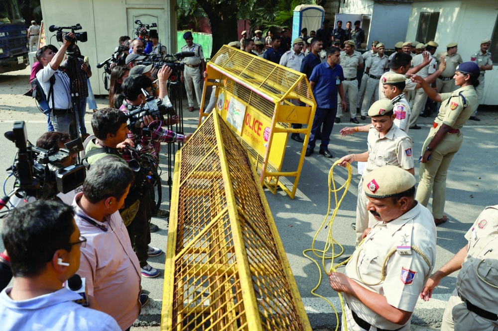 Police and media gather outside the residence of India's main opposition Congress party leader Rahul Gandhi after he was disqualified by India's parliament as a lawmaker in New Delhi. - Reuters