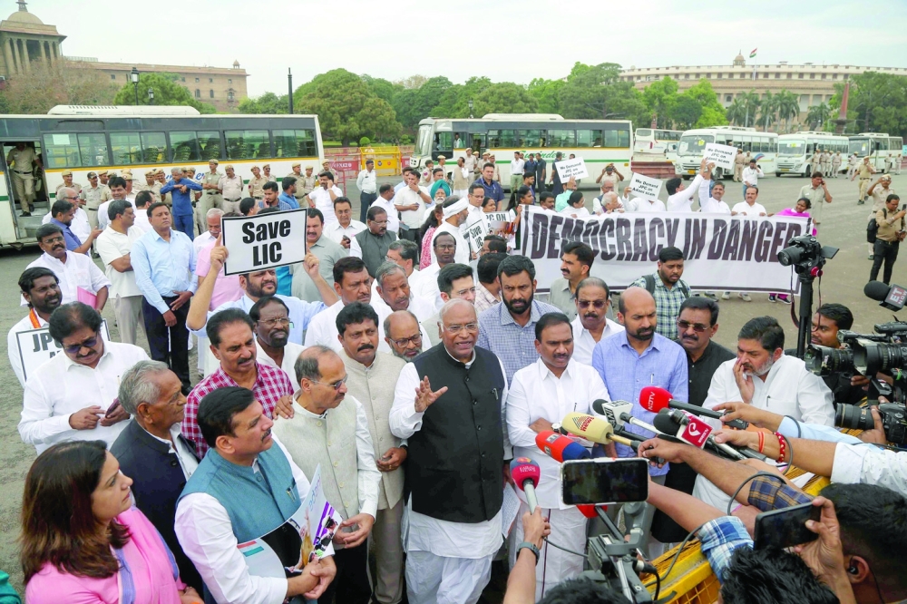 India's Congress party president Mallikarjun Kharge along with MPs of various opposition parties speak with the members of the media during a protest march towards presidential palace Rashtrapati Bhawan, against conviction of Congress party member Rahul Gandhi in a criminal defamation case during a demonstration in New Delhi. - AFP