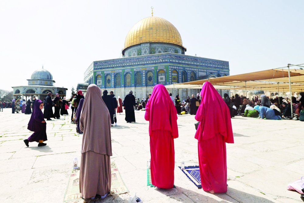 Children pray at the Al Aqsa mosque compound in Jerusalem on Friday.  — AFP