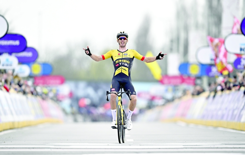 Jumbo-Visma's French rider Christophe Laporte celebrates as he cyles to the finish line to win the men elite race 'Dwars Door Vlaanderen' cycling race, 183,5 km from Roeselare to Waregem, on March 29, 2023. Belgium OUT
 (Photo by JASPER JACOBS / BELGA / AFP)

