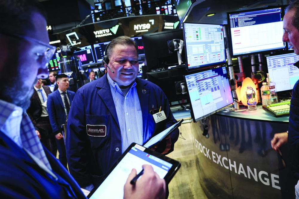 Traders work on the floor of the New York Stock Exchange (NYSE) in New York City. - Reuters