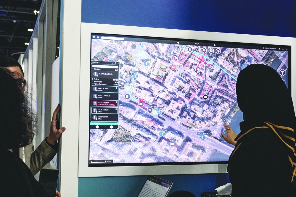 An attendee interacts with a display at a booth for Presight AI, a firm based in the UAE, that sells software that can identify people, store data about their appearance and track their routes, during a police conference in Dubai.
