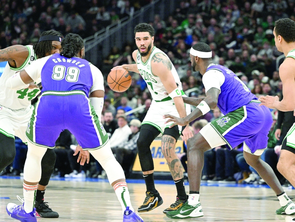 Boston Celtics forward Jayson Tatum (0) dribbles up the court against Milwaukee Bucks forward Bobby Portis (9) in the second half at Fiserv Forum. -- USA TODAY Sports

