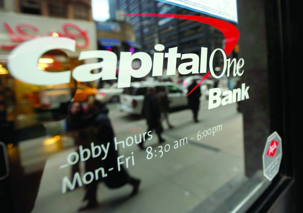 People walk past a Capital One banking center in New York's financial district